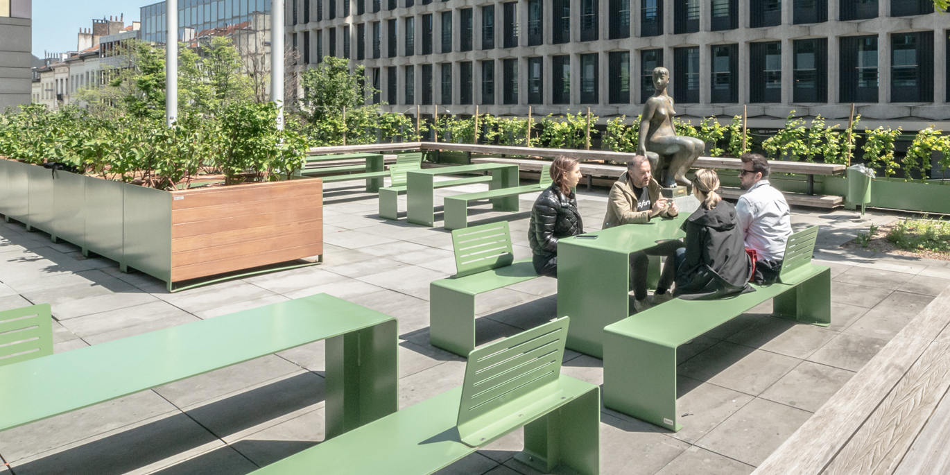 Band range of backless benches and table in green color with Urbe planters